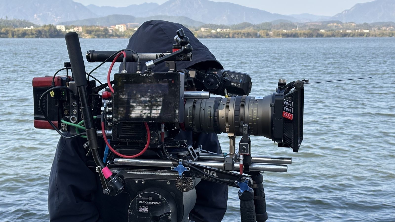Camera setup with an Angénieux EZ-3 lens, water in the background